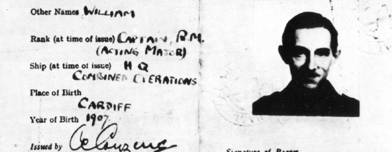Part of a blck-and-white military identity card for a man born in Cardiff in 1907. It contains a rather shadowy photo of a man's head and shoulders.